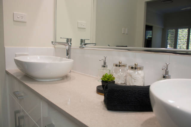White bathroom vanity with granite bench